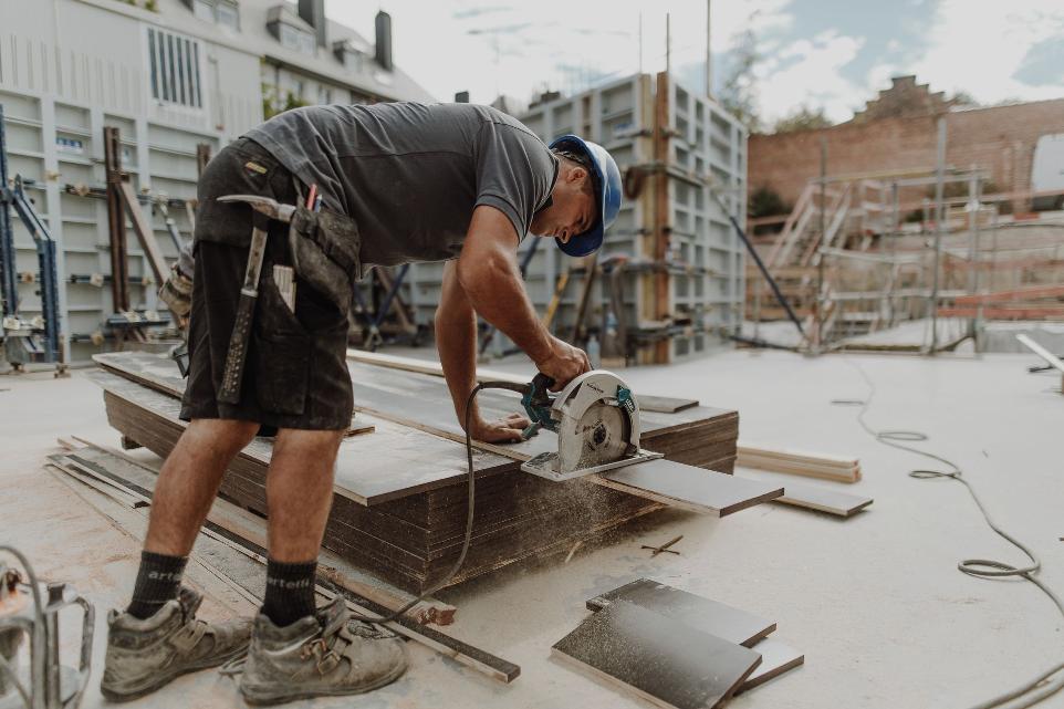 Worker cutting wood panels